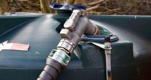 domestic home heating oil tank being refilled with 28 sec kerosene in a garden in northern ireland uk